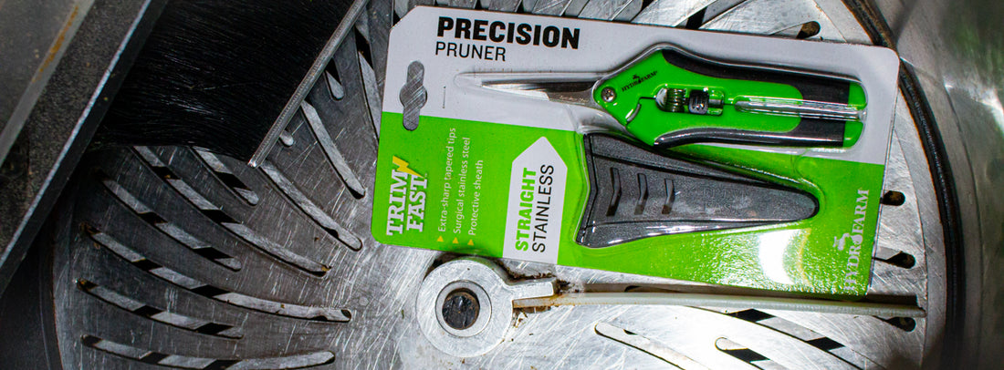 a GreenBroz machine trimmer with a pair of Hydrofarm Precision Pruners